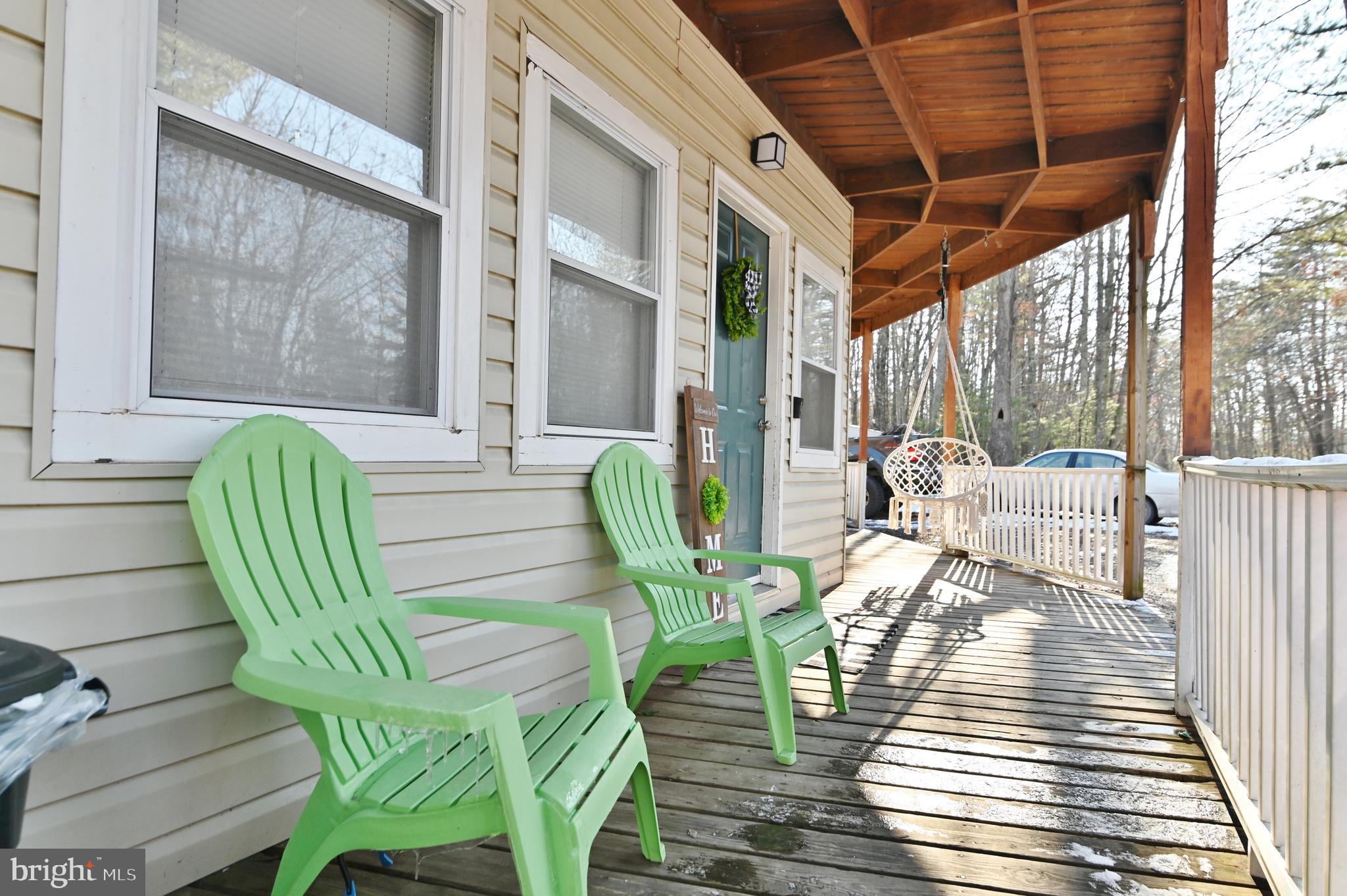 8148 Supinlick Ridge Road Mount Jackson, VA 22842 - Photo 8 of 39 a view of a patio with table and chairs and wooden floor