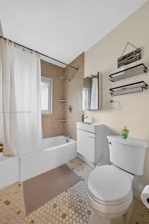 a bathroom with a toilet a sink and bathtub