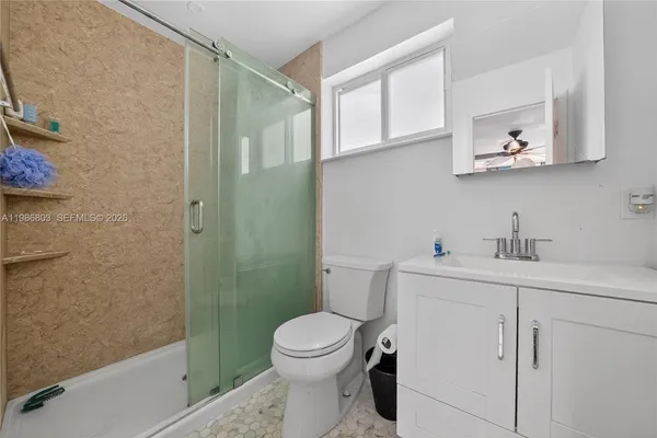 a bathroom with a toilet sink and shower