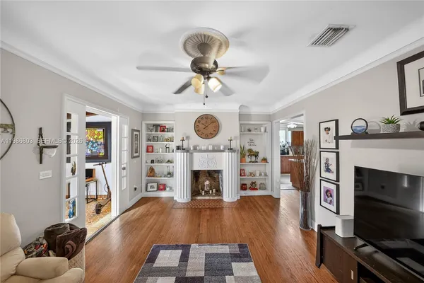 a living room with furniture a fireplace and flat screen tv