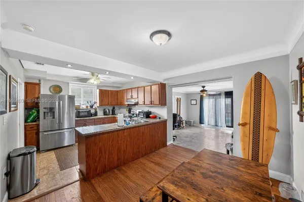 a large kitchen with a table and chairs