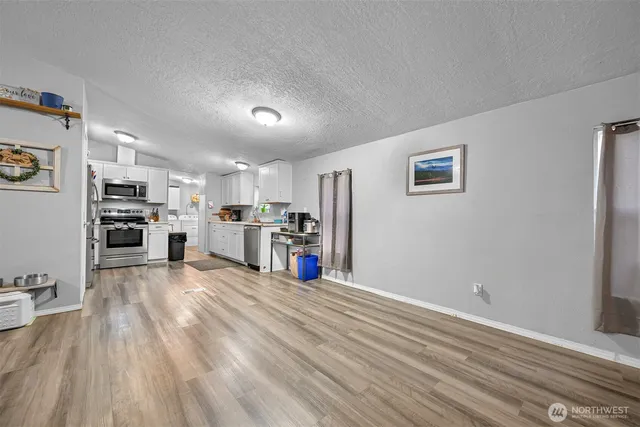 a view of kitchen with furniture and wooden floor
