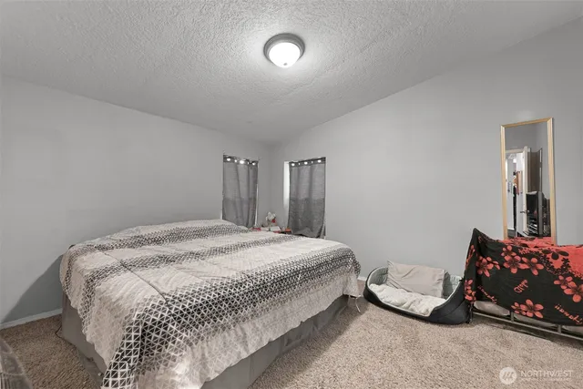 a bedroom with a bed and a chair