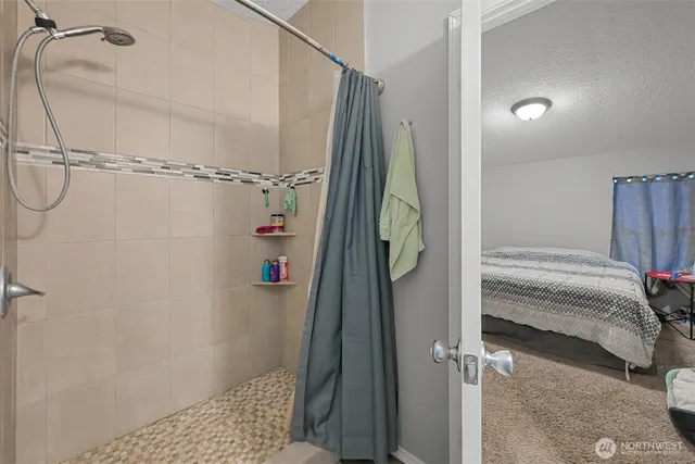 a bathroom with a shower and a tub