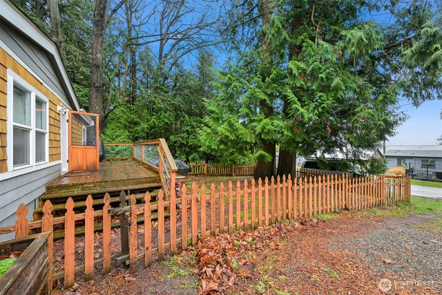 a view of a house with wooden fence