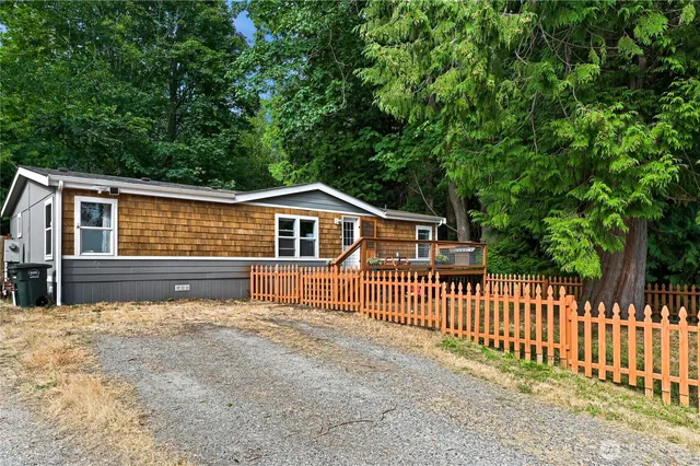 a front view of a house with wooden fence