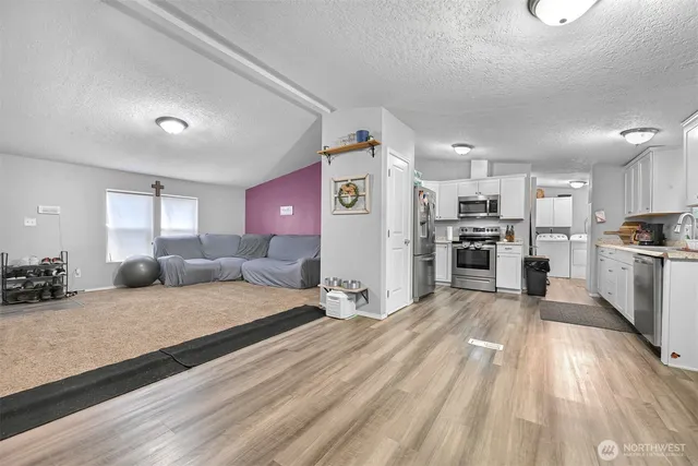 a large bedroom with a bed and lots of wooden floor