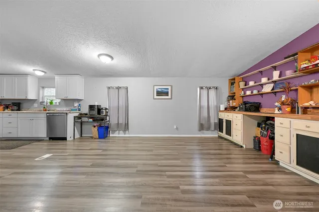 a view of a kitchen with cabinets and wooden floor