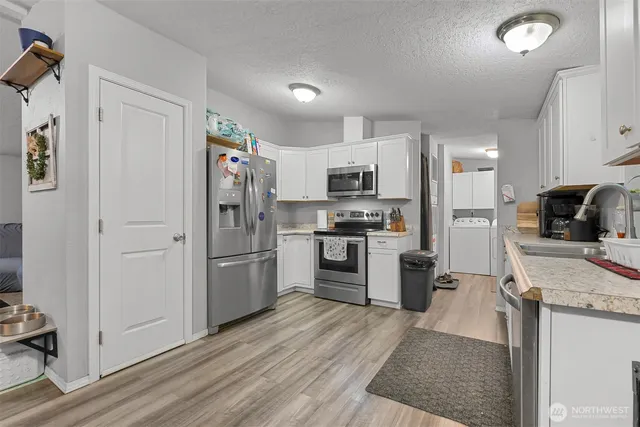 a kitchen with a refrigerator a stove top oven a sink and dishwasher