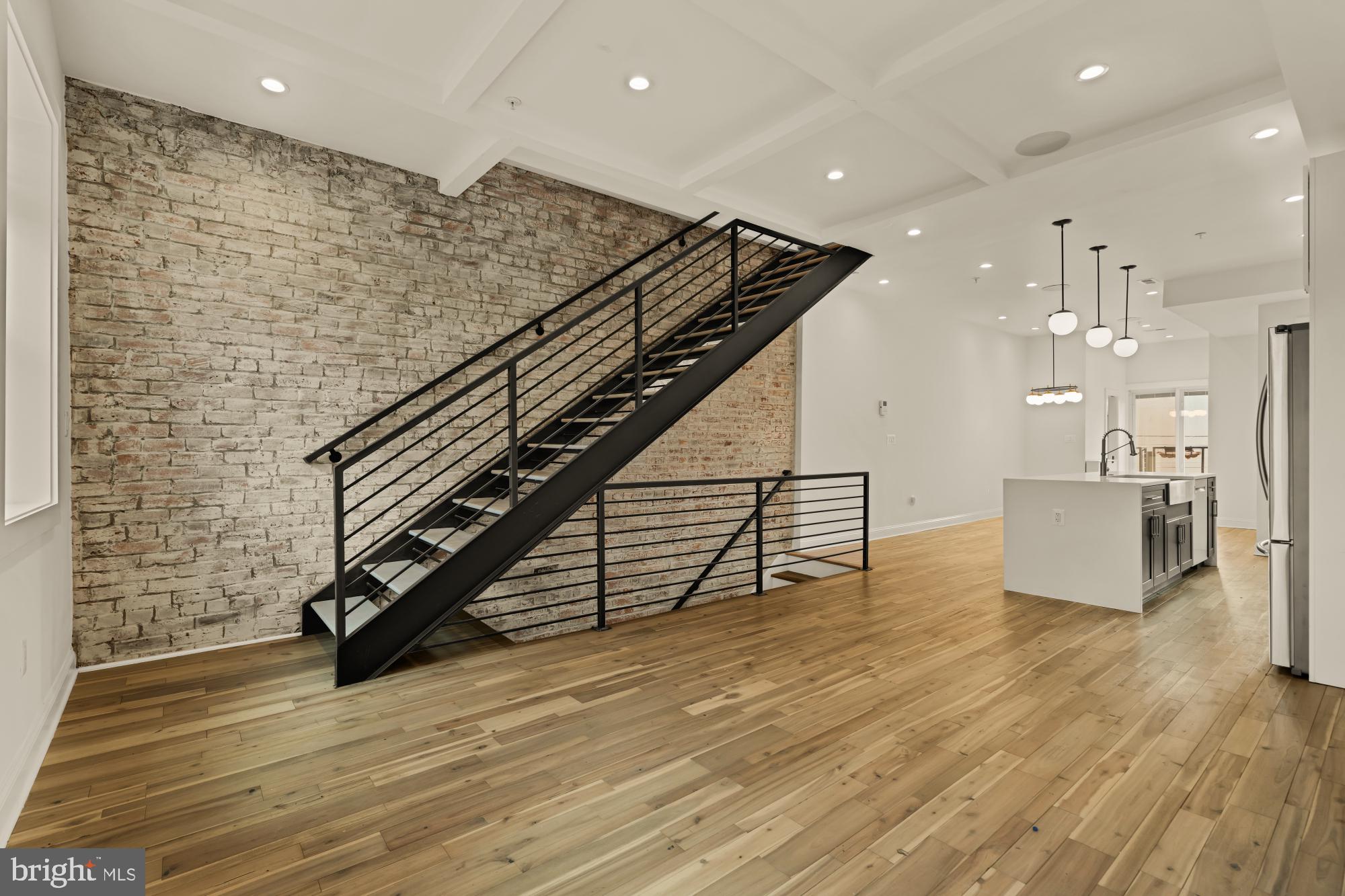 1310 Spring Road Northwest, Unit PHB Washington, DC 20010 - Photo 11 of 18 a view of a hall with wooden floor and stairs