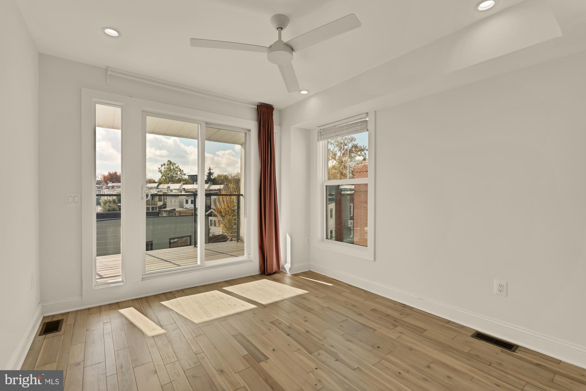 1310 Spring Road Northwest, Unit PHB Washington, DC 20010 - Photo 13 of 18 a view of empty room with wooden floor and fan