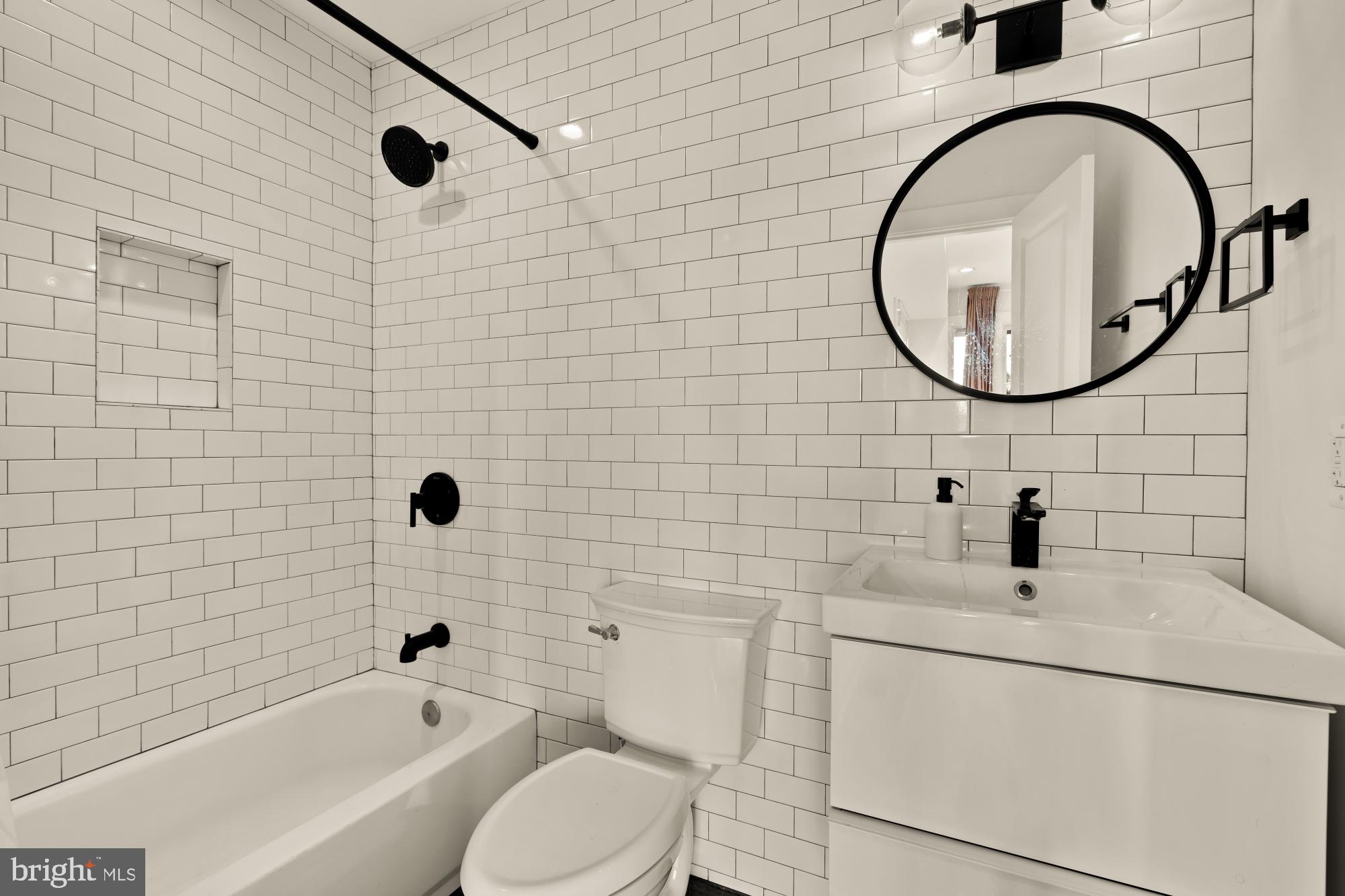 1310 Spring Road Northwest, Unit PHB Washington, DC 20010 - Photo 14 of 18 a bathroom with a sink a toilet and a mirror