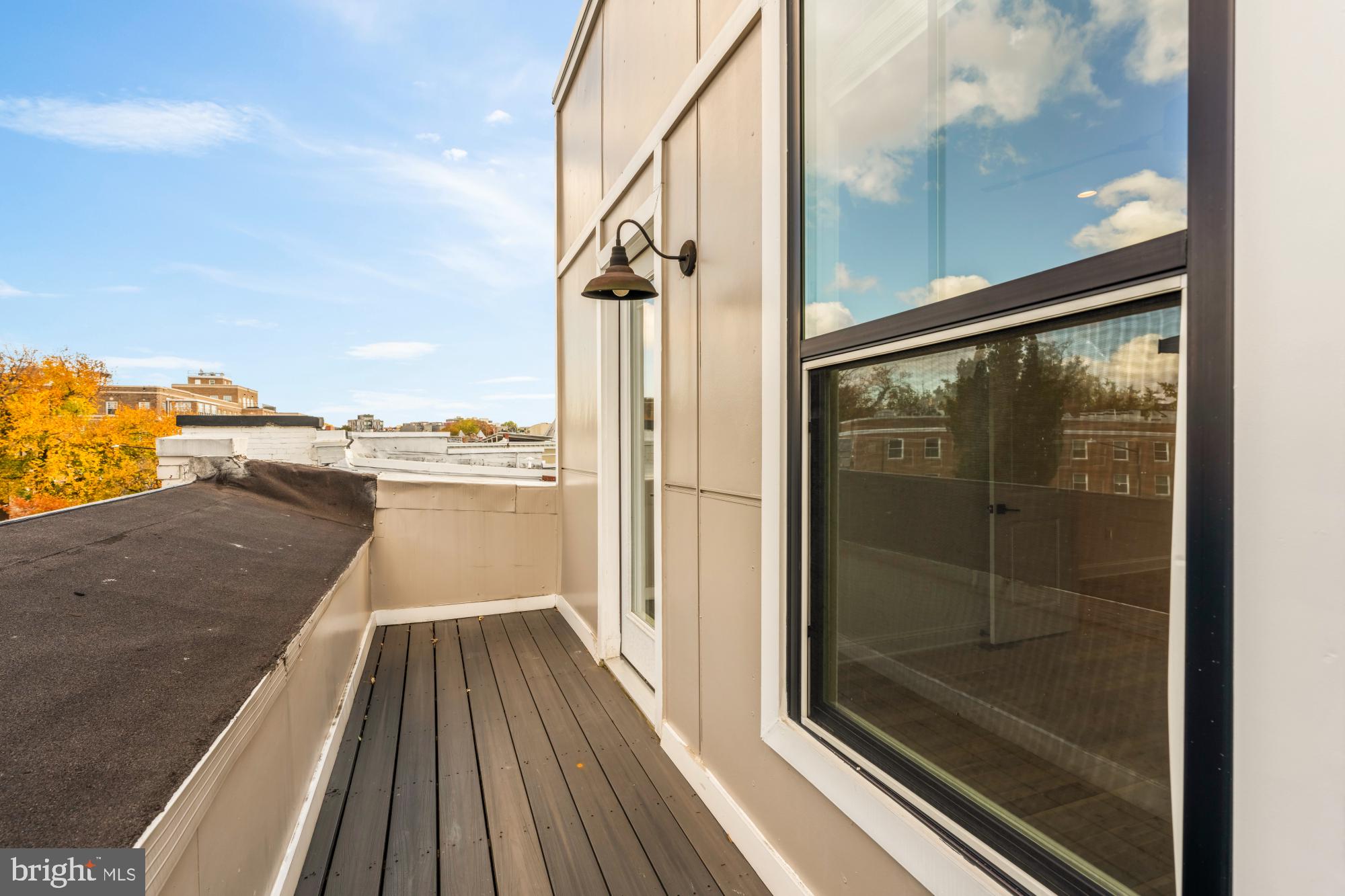 1310 Spring Road Northwest, Unit PHB Washington, DC 20010 - Photo 16 of 18 a view of a balcony with floor to ceiling windows with wooden floor