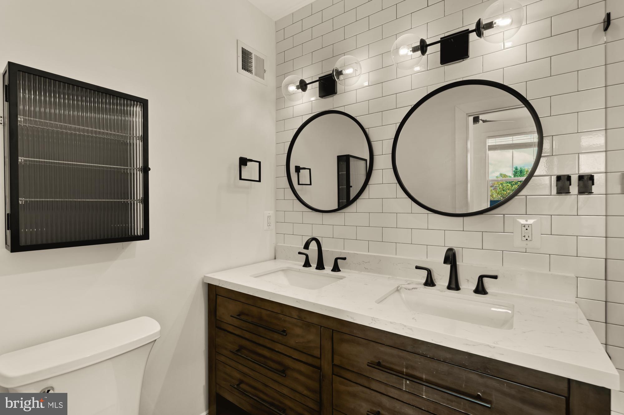 1310 Spring Road Northwest, Unit PHB Washington, DC 20010 - Photo 18 of 18 a bathroom with a sink and a mirror