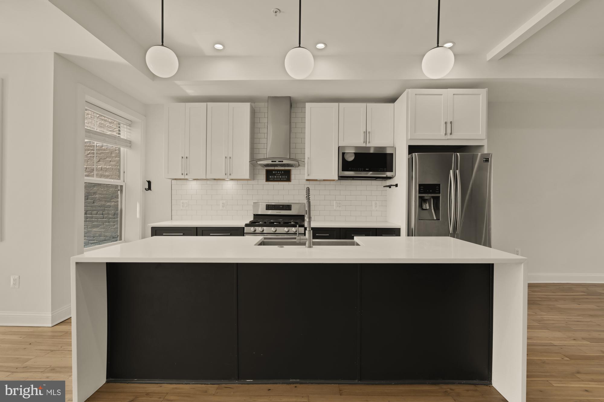 1310 Spring Road Northwest, Unit PHB Washington, DC 20010 - Photo 5 of 18 a kitchen with stainless steel appliances a stove refrigerator and cabinets