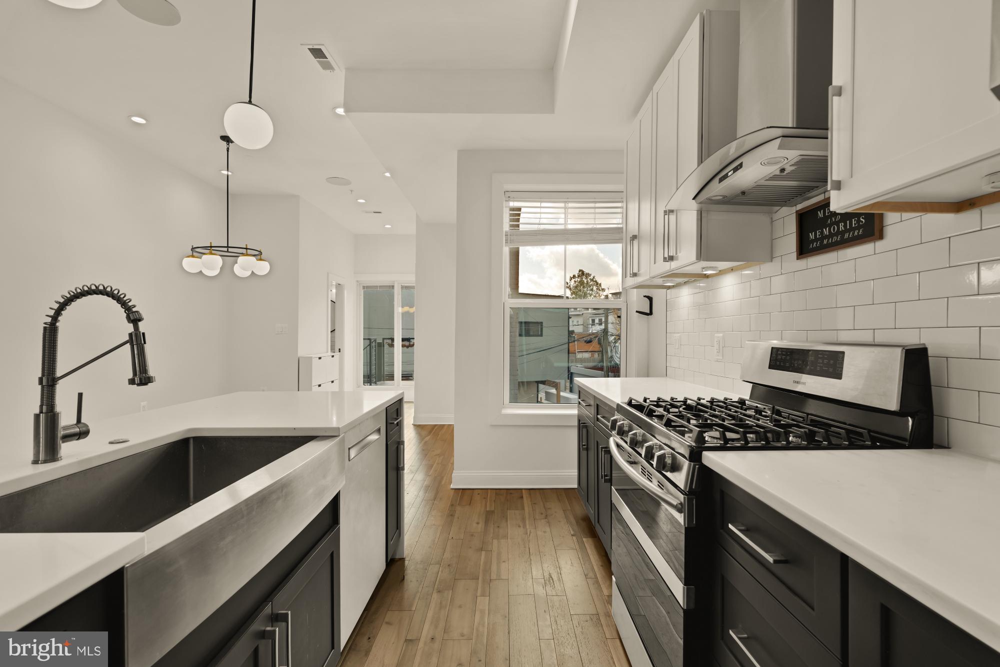 1310 Spring Road Northwest, Unit PHB Washington, DC 20010 - Photo 6 of 18 a kitchen with granite countertop a sink stove and cabinets