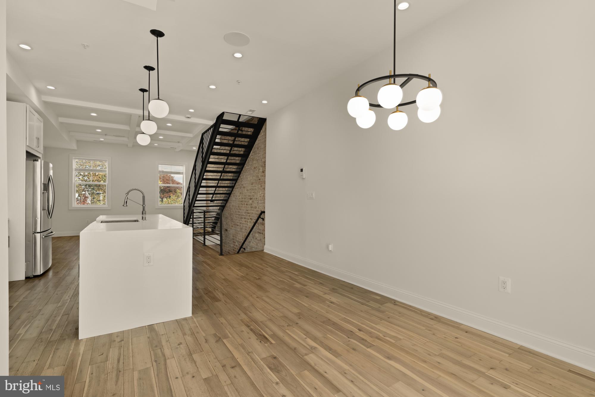 1310 Spring Road Northwest, Unit PHB Washington, DC 20010 - Photo 7 of 18 a view of a room with wooden floor and lots of racks