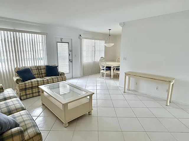 a view of a tennis ground and large trees