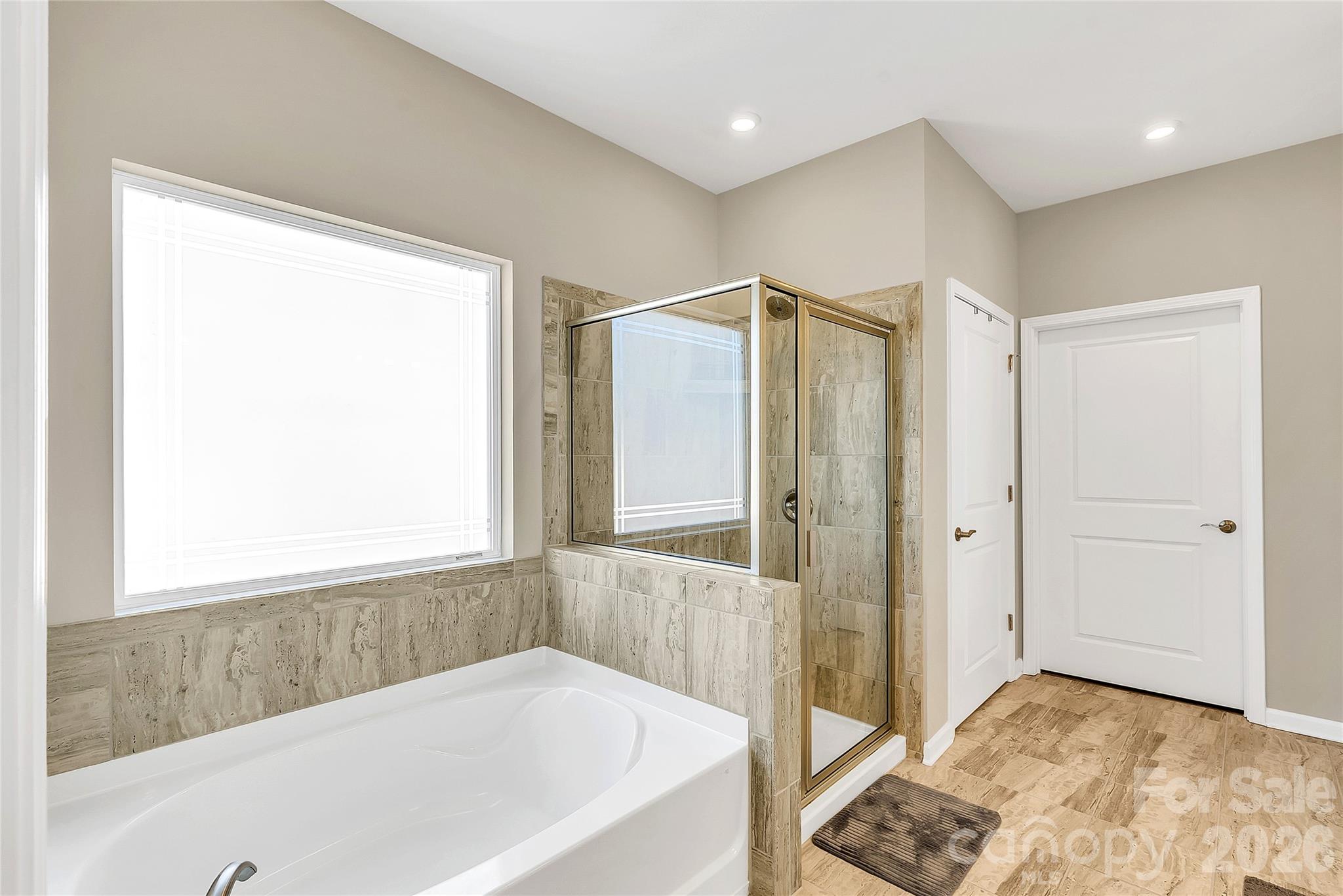 14421 Holbrooks Road Huntersville, NC 28078 - Photo 16 of 29 a bathroom with a bathtub and a shower