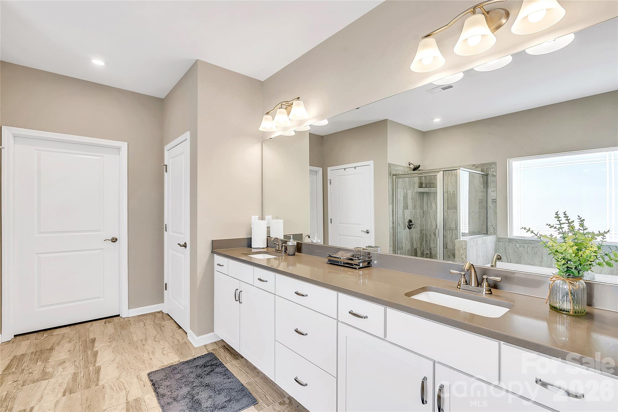 14421 Holbrooks Road Huntersville, NC 28078 - Photo 17 of 29 a bathroom with a double vanity sink and a mirror