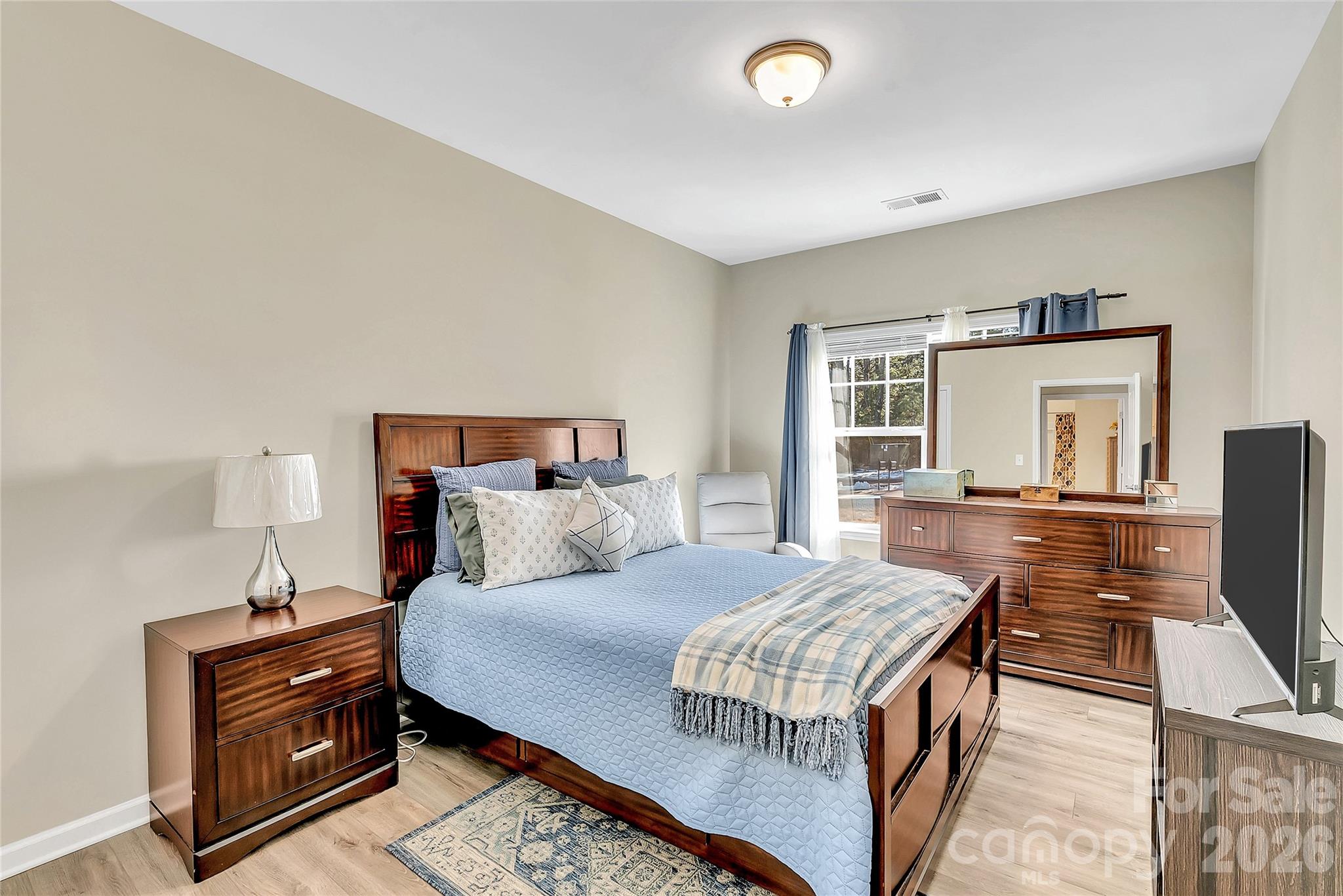 14421 Holbrooks Road Huntersville, NC 28078 - Photo 21 of 29 a bedroom with a bed and a flat screen tv