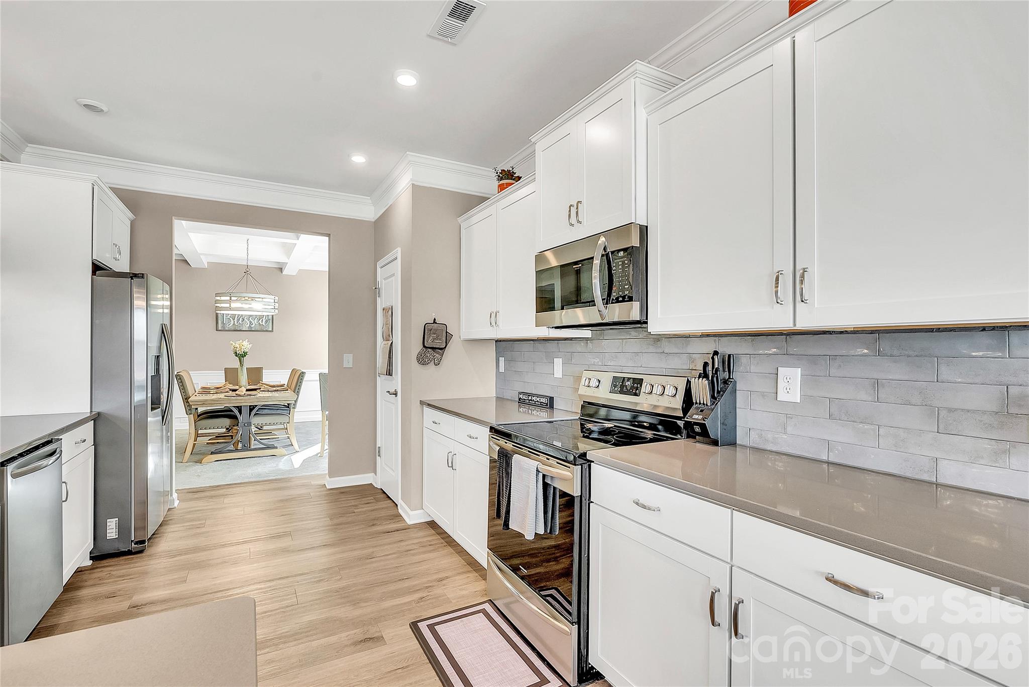 14421 Holbrooks Road Huntersville, NC 28078 - Photo 5 of 29 a kitchen with stainless steel appliances a stove sink microwave and cabinets