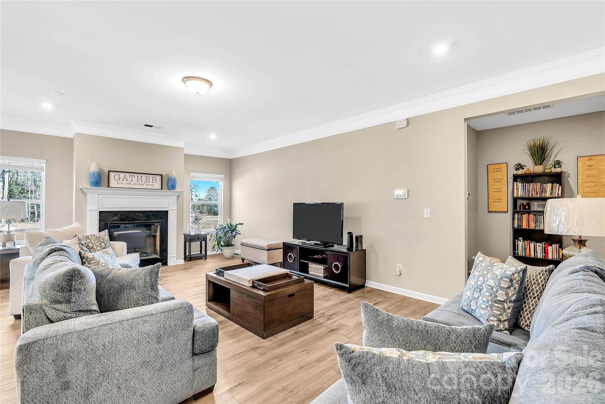 14421 Holbrooks Road Huntersville, NC 28078 - Photo 9 of 29 a living room with furniture and a fireplace