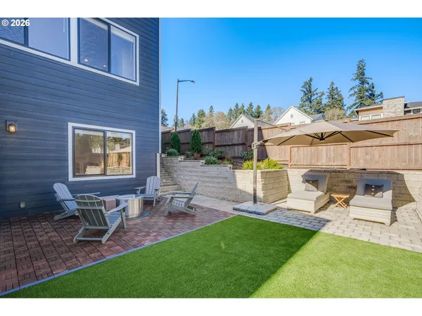 a view of a backyard with sitting area