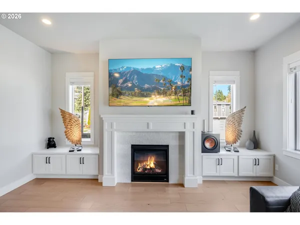 a living room with furniture a fireplace and a flat screen tv