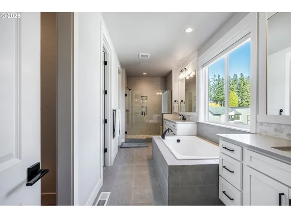 a bathroom with a sink a large mirror and shower