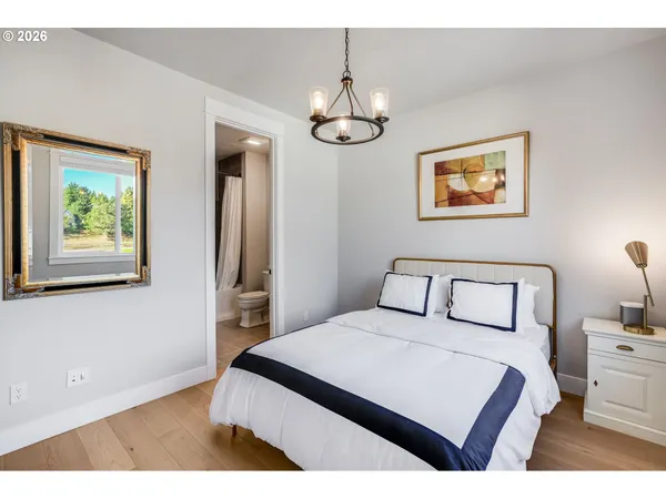 a bedroom with a bed and a painting on the wall