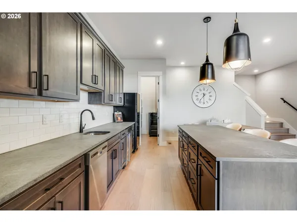 a kitchen with a sink a stove and cabinets