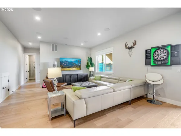 a living room with furniture a rug and a chair
