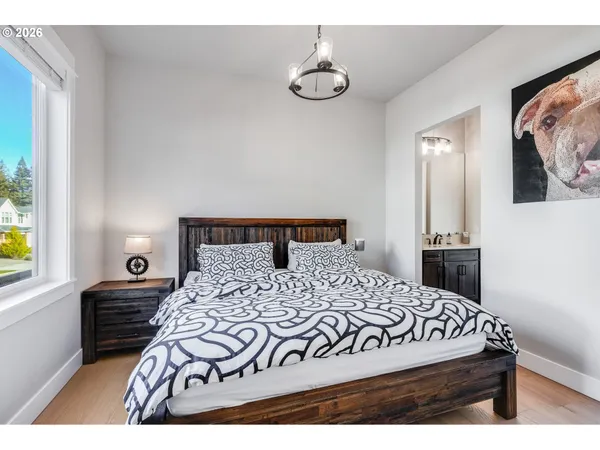 a bedroom with a bed and a view of kitchen