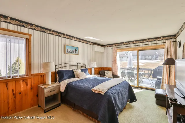 a bedroom with a bed and a night stand