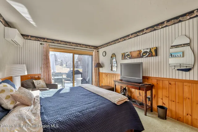 a bedroom with furniture and a flat screen tv