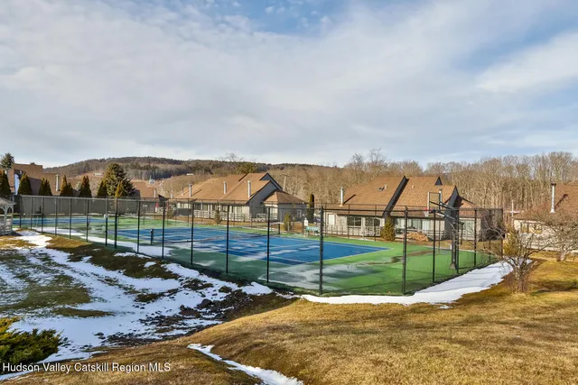 a view of a house with a yard covered in snow