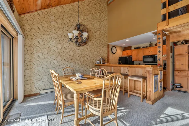 a view of a dining room with furniture and chandelier