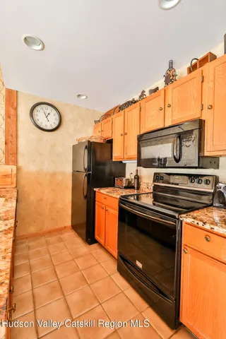 a kitchen with stainless steel appliances granite countertop a stove a refrigerator and a microwave