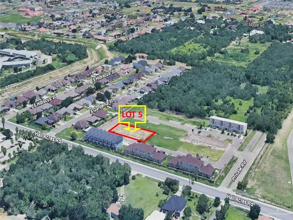 an aerial view of a tennis ground and a yard