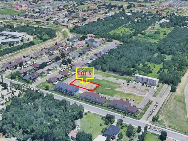an aerial view of a tennis ground and a yard