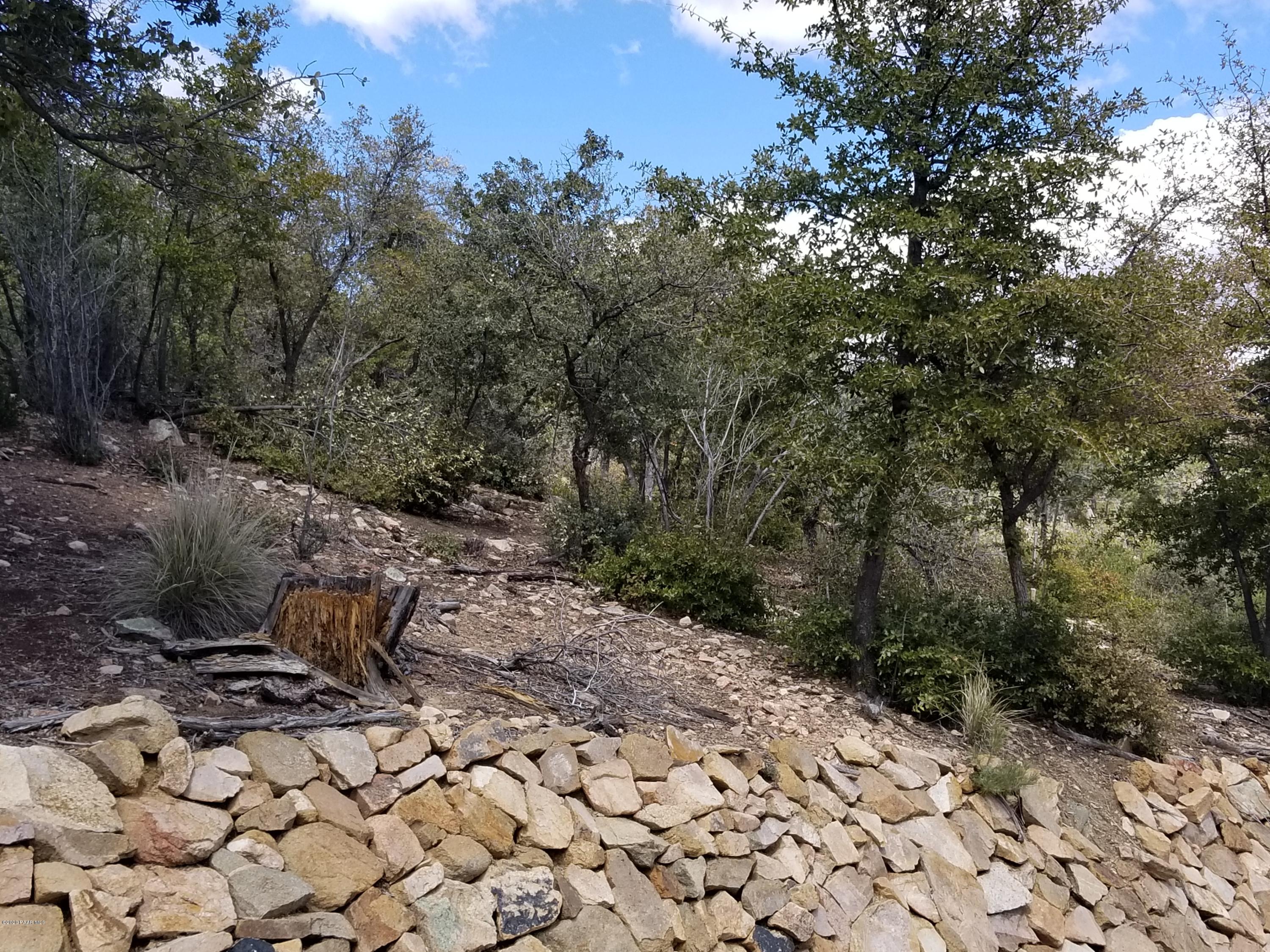 1050 High Valley Ranch Road Prescott, AZ 86303 - Photo 11 of 31 a wooden bench with view of trees