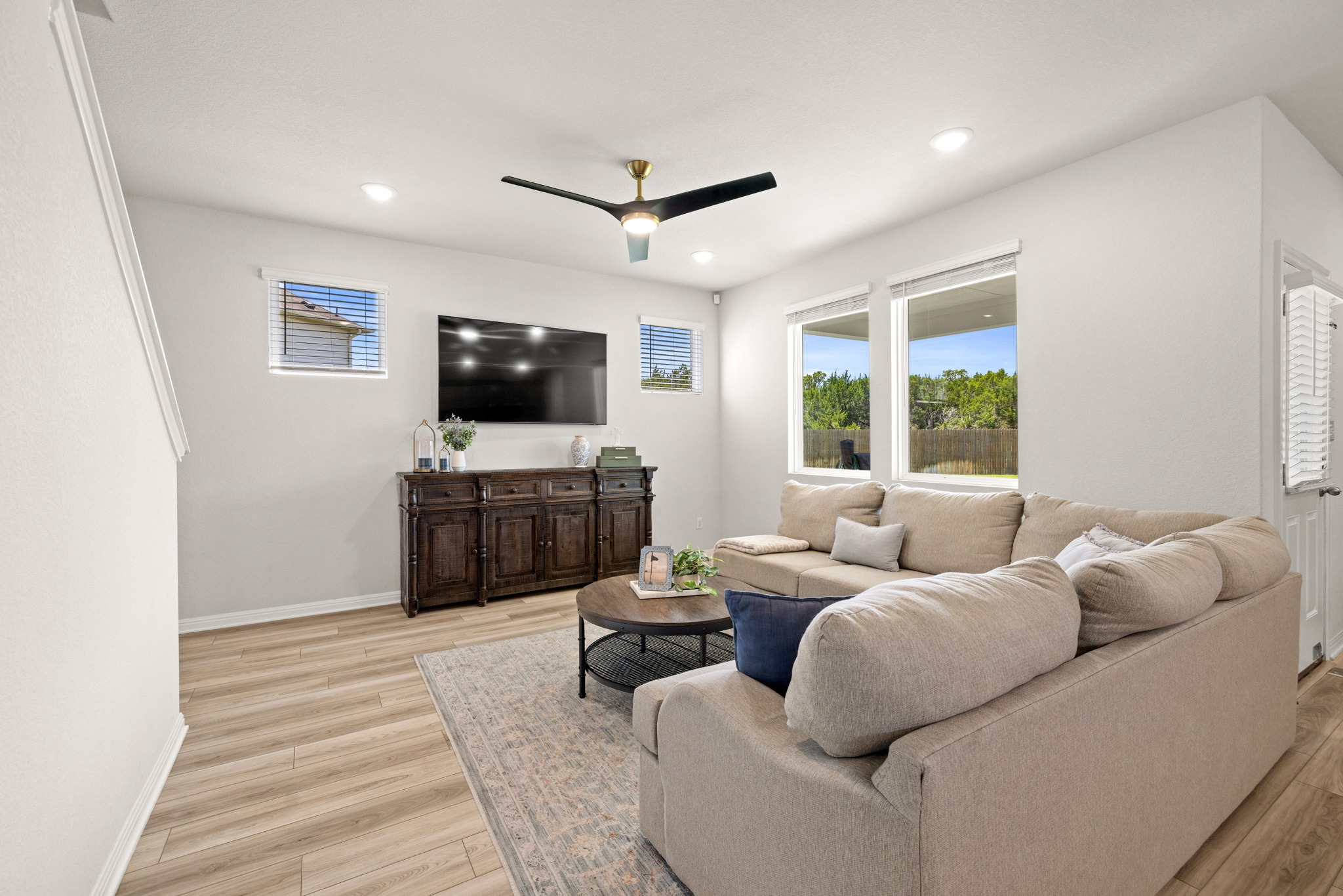 2049 Winston Way Leander, TX 78641 - Photo 6 of 35 The large living room overlooks the lush backyard.