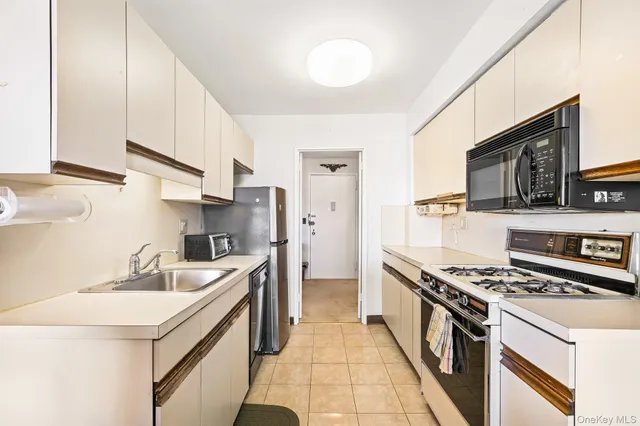 a kitchen with a sink cabinets and window