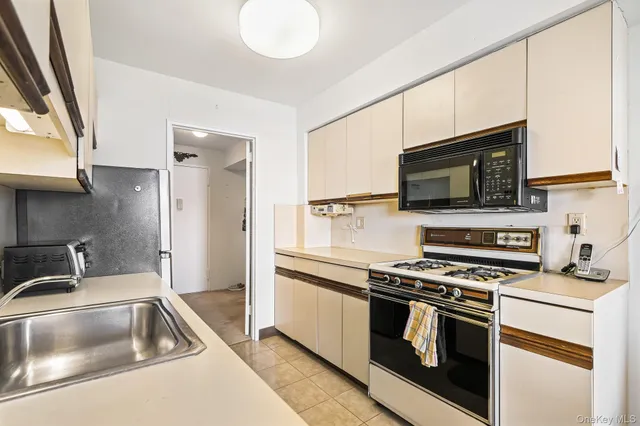 a kitchen with stainless steel appliances a sink stove and refrigerator