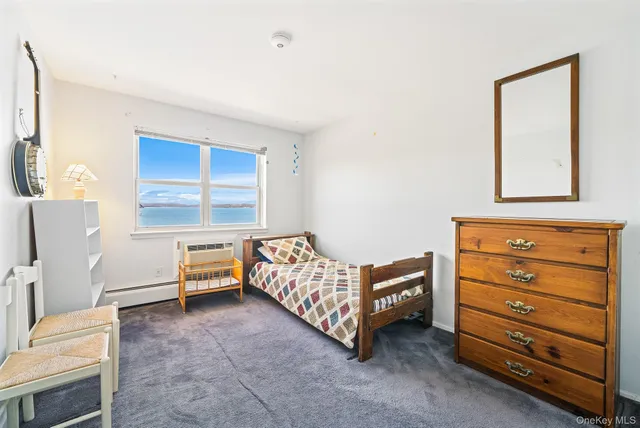 a spacious bedroom with a bed and a window