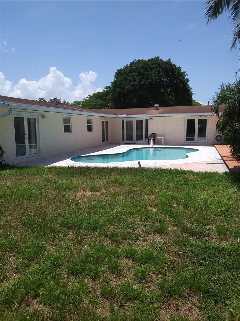 4508 West Park Road Hollywood, FL 33021 - Photo 1 of 13 a front view of a house with a yard and garage