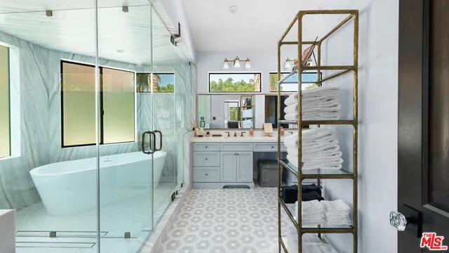 a bathroom with a double vanity sink mirror and bathtub