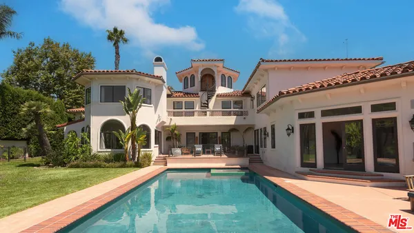 a view of the house with patio porch and tables