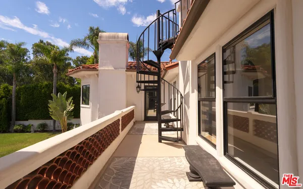 a view of a balcony with furniture